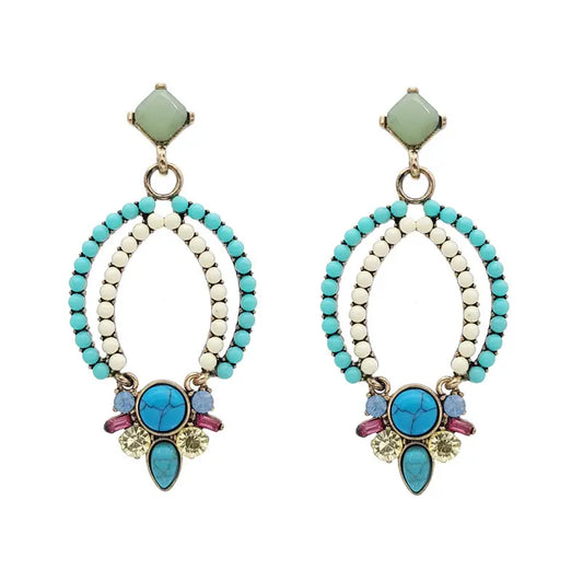 Add a splash of fun and unique flair to any outfit with these stunning Bollywood Earrings. Crafted with an antique gold platting and a mix of turquoise, white, pink and clear stones, these earrings radiate with Indian chic.  Bollywood Earrings. thejewelled.au